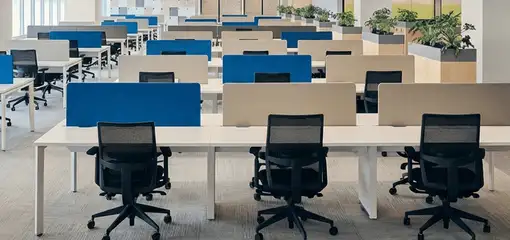 Modern open-plan office space featuring clean workstations, ergonomic chairs, and sanitized carpets provided by professional office cleaning services in Stamford, CT.